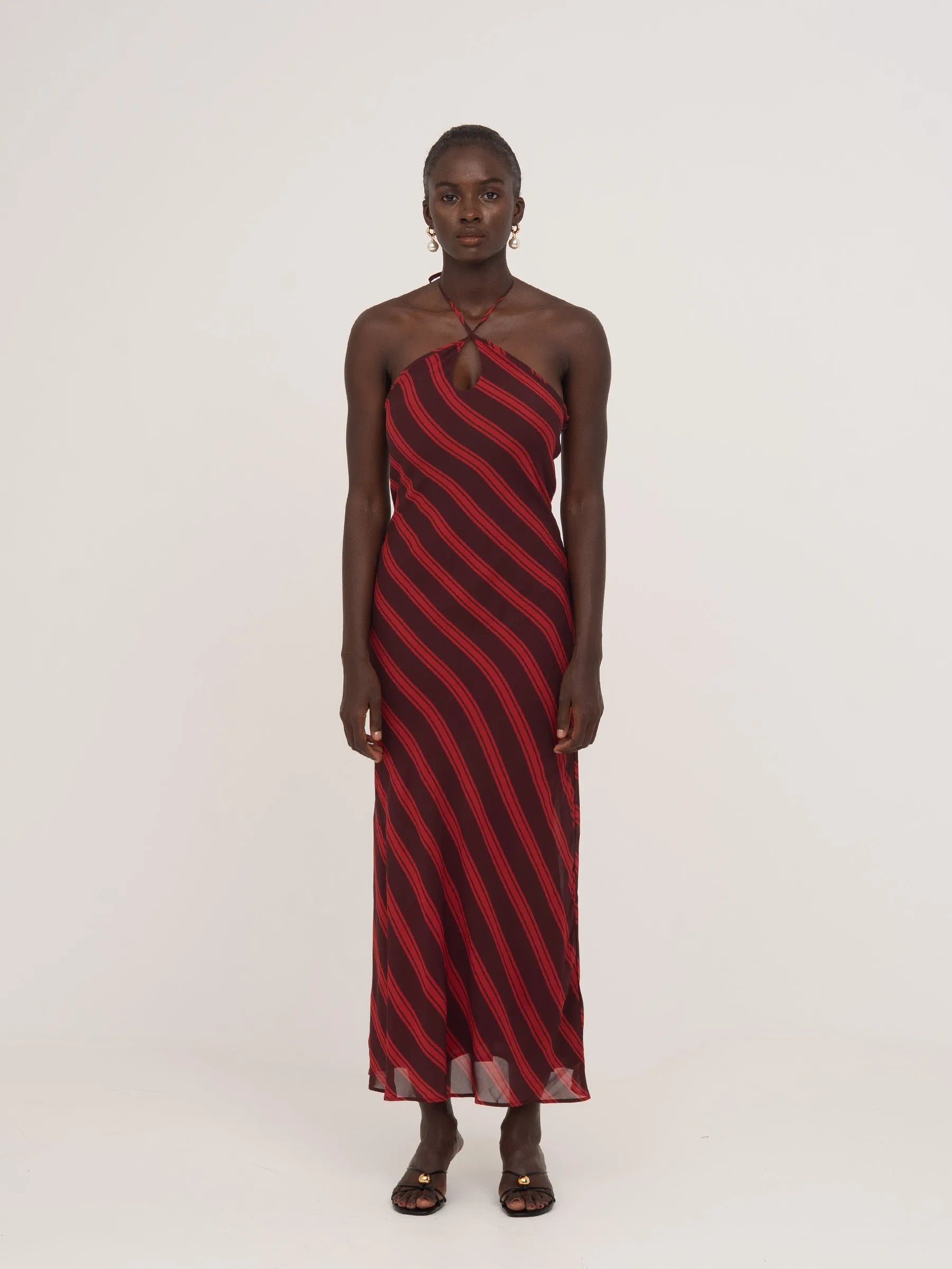 Long burgundy and red striped dress with a bow at the back