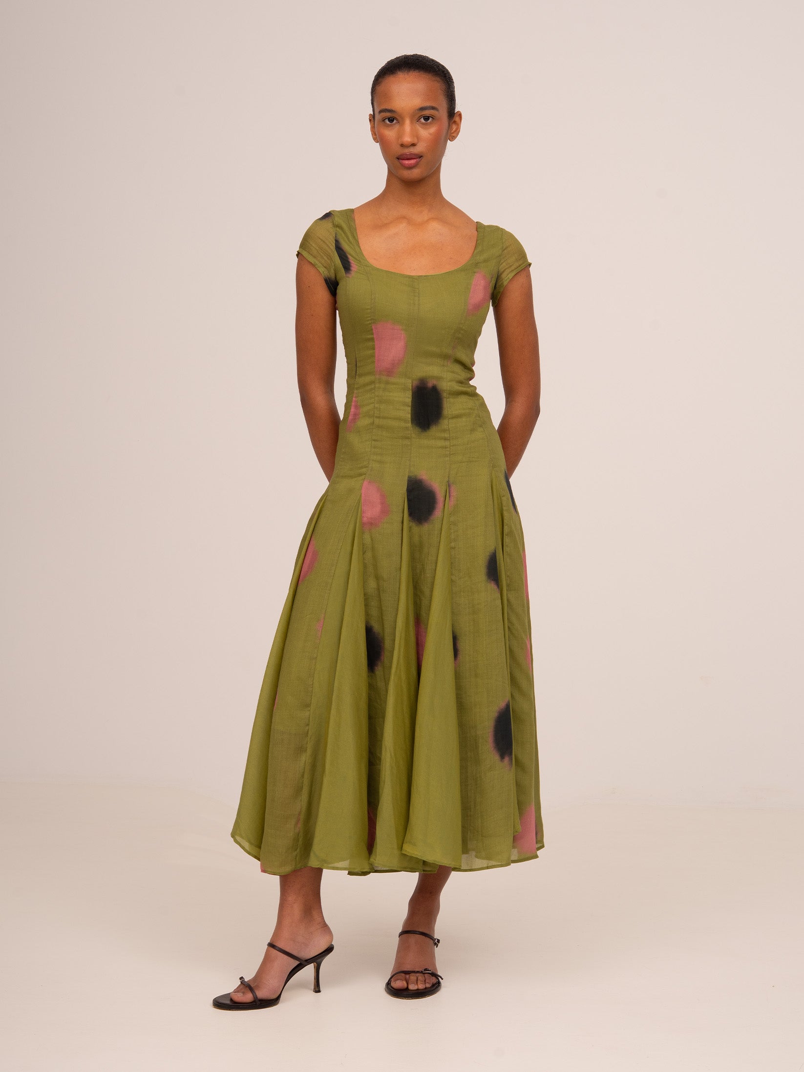 Vestido de mujer con estampado de lunares verdes y blancos, corte fluido de ocasión, escote amplio y manga corta, ideal para eventos y looks elegantes.