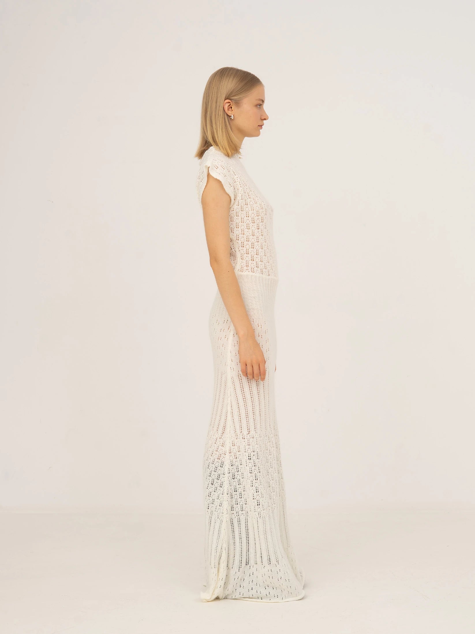 Long white knit dress with fitted waist