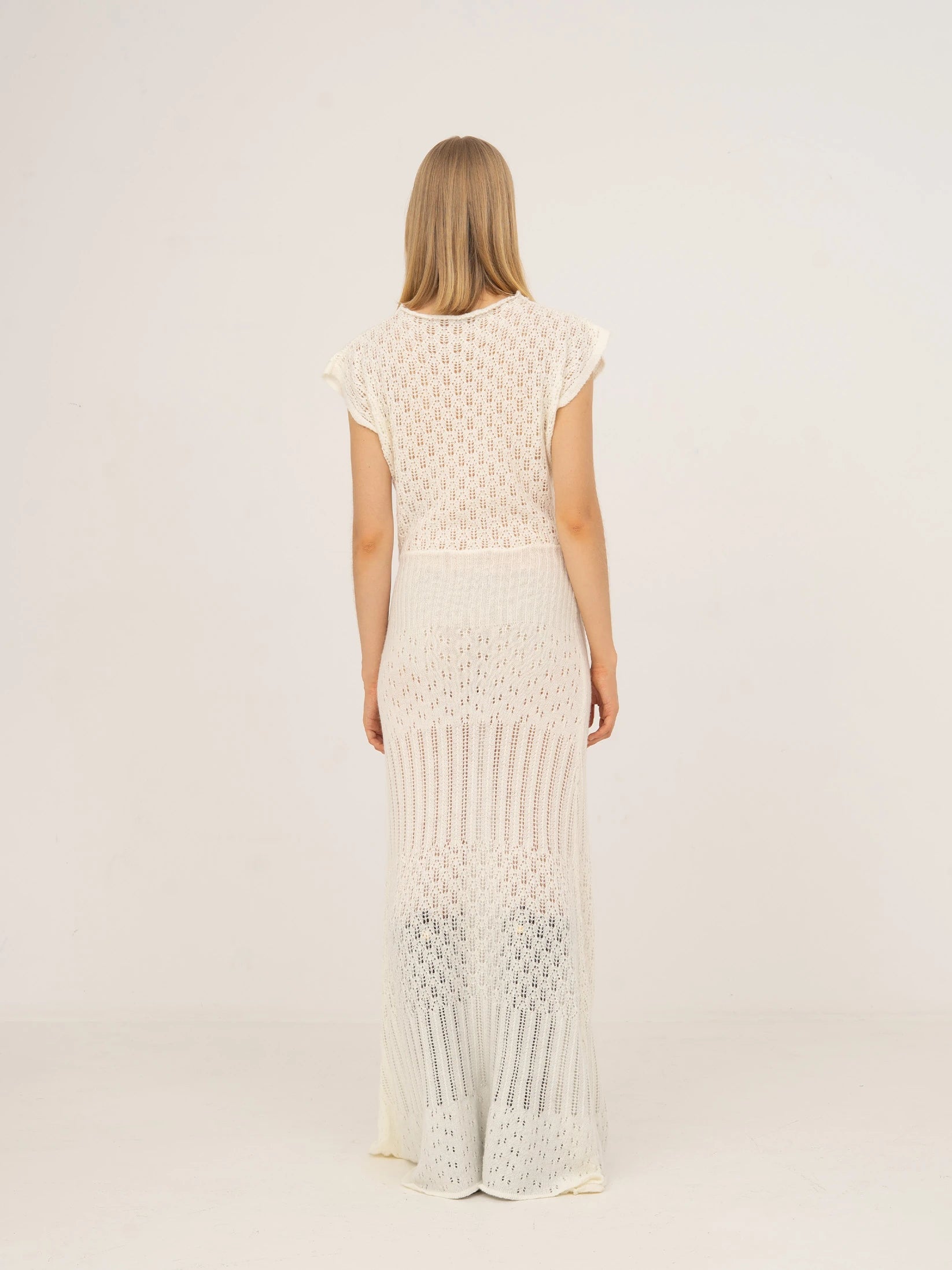 Long white knit dress with fitted waist