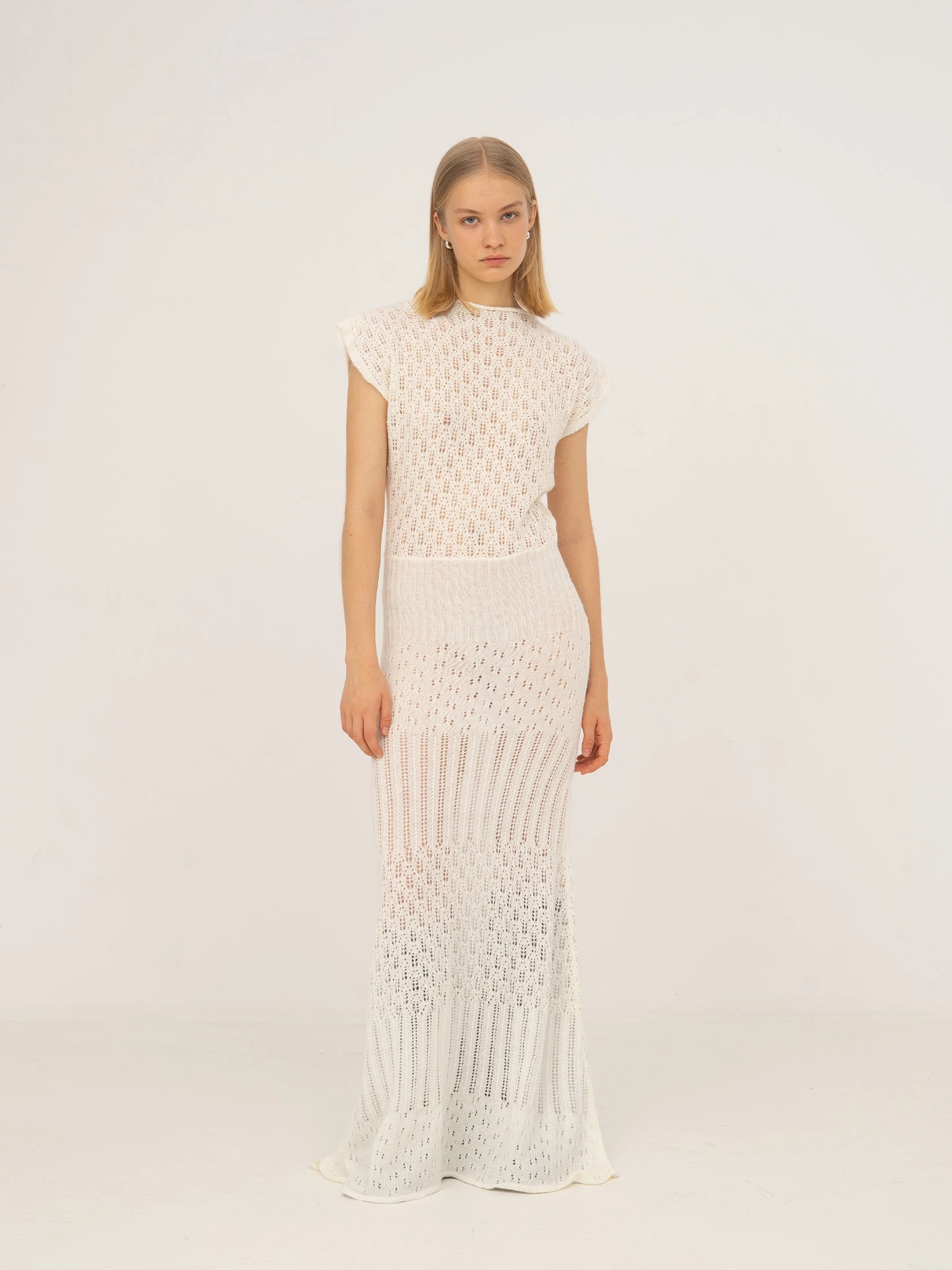 Long white knit dress with fitted waist
