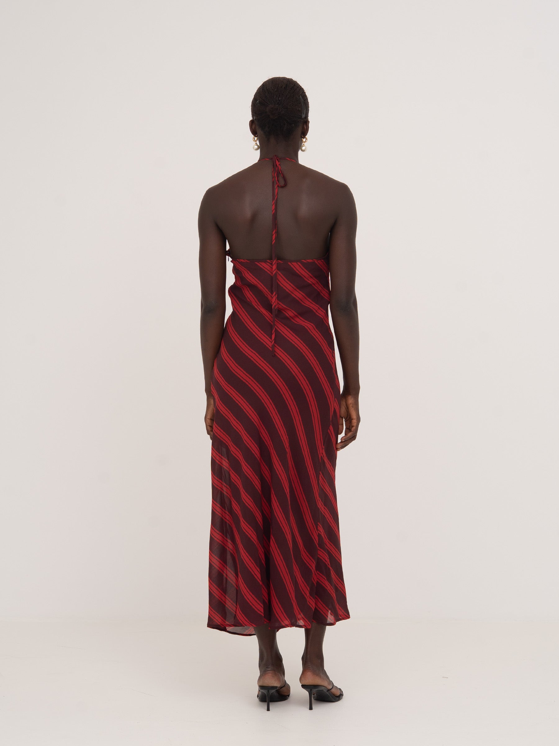 Long burgundy and red striped dress with a bow at the back